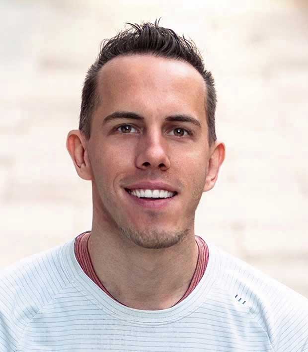 Headshot of Patrick Reiner, smiling, against a neutral background.